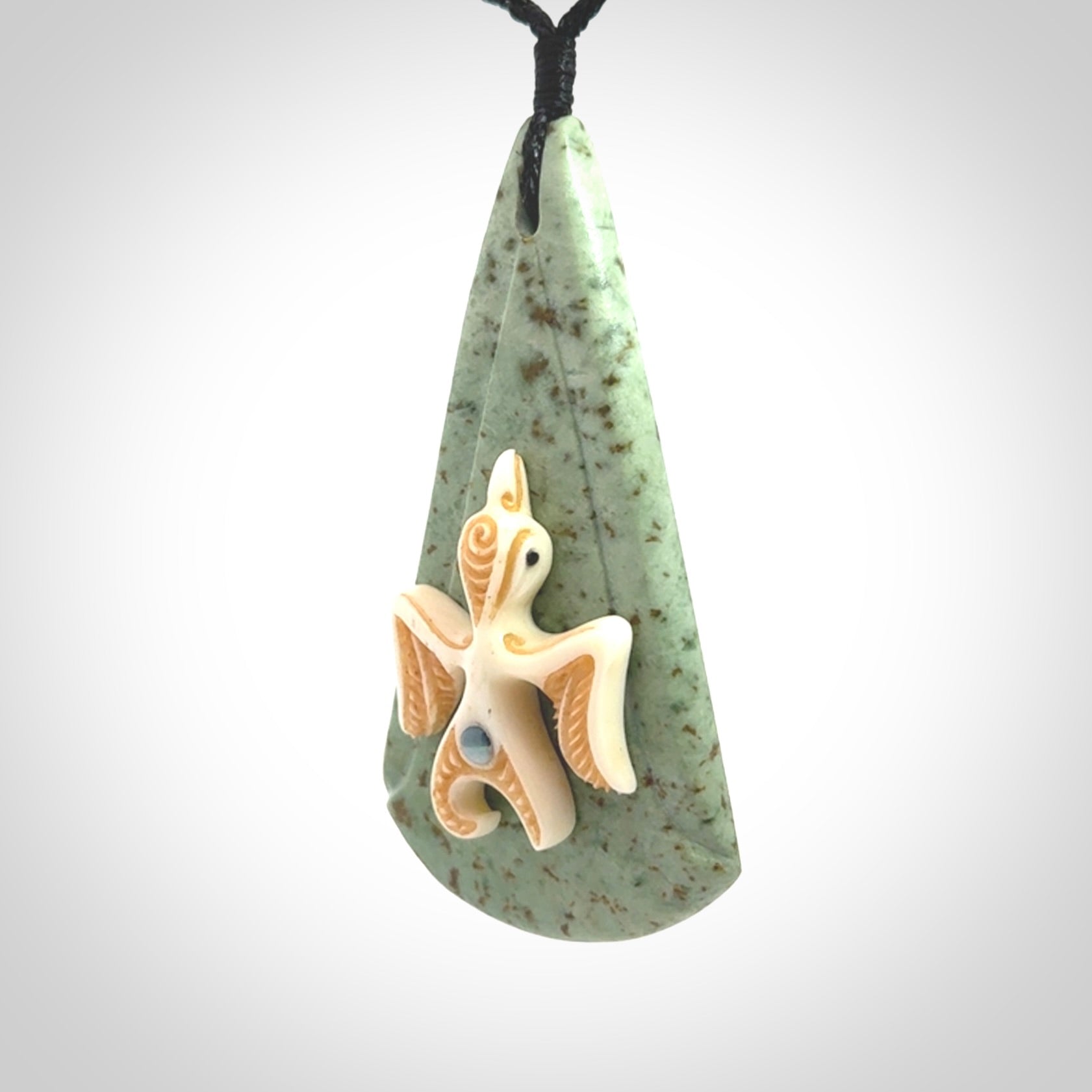 This is a wonderful New Zealand Jade and bone drop pendant with bird carving.