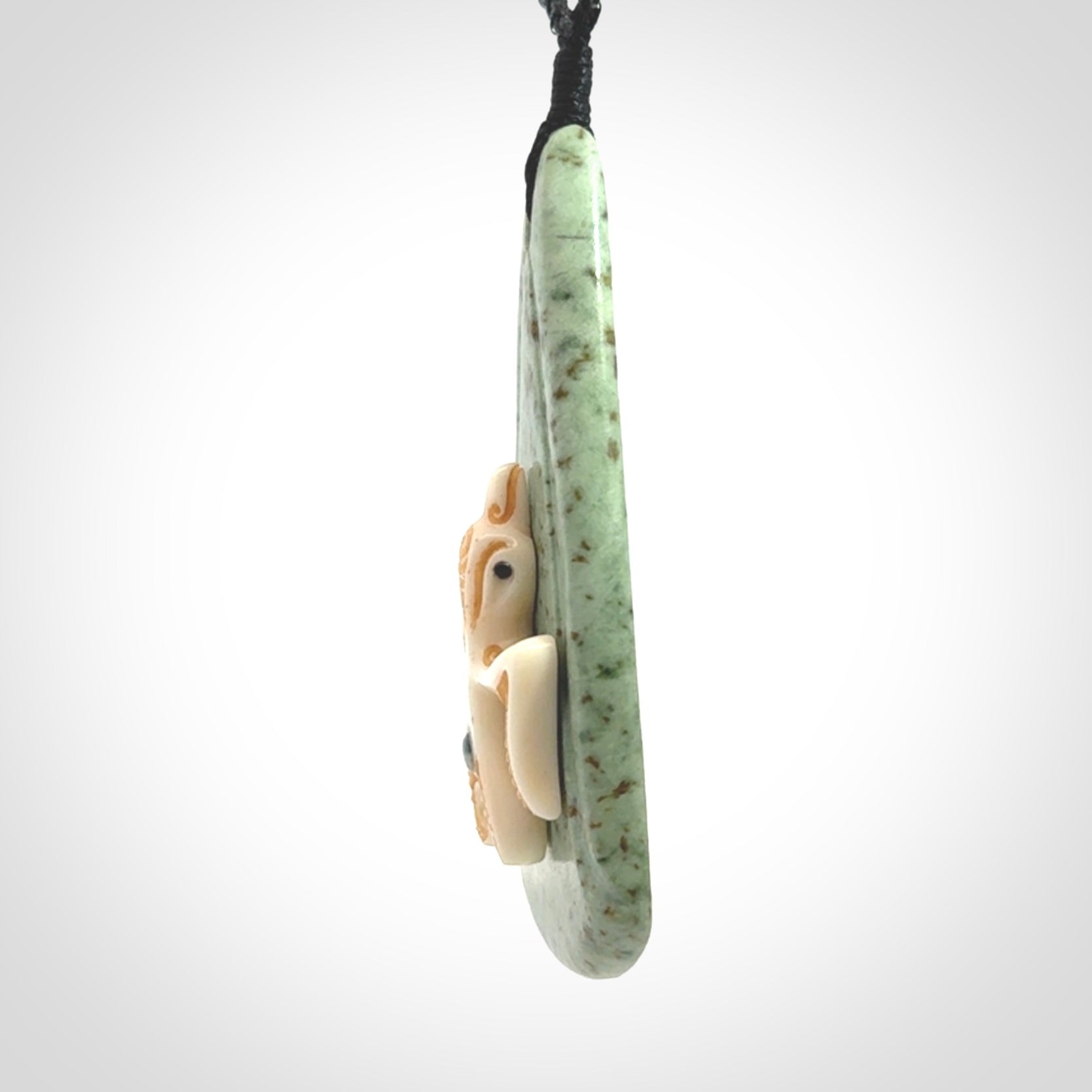 This is a wonderful New Zealand Jade and bone drop pendant with bird carving.