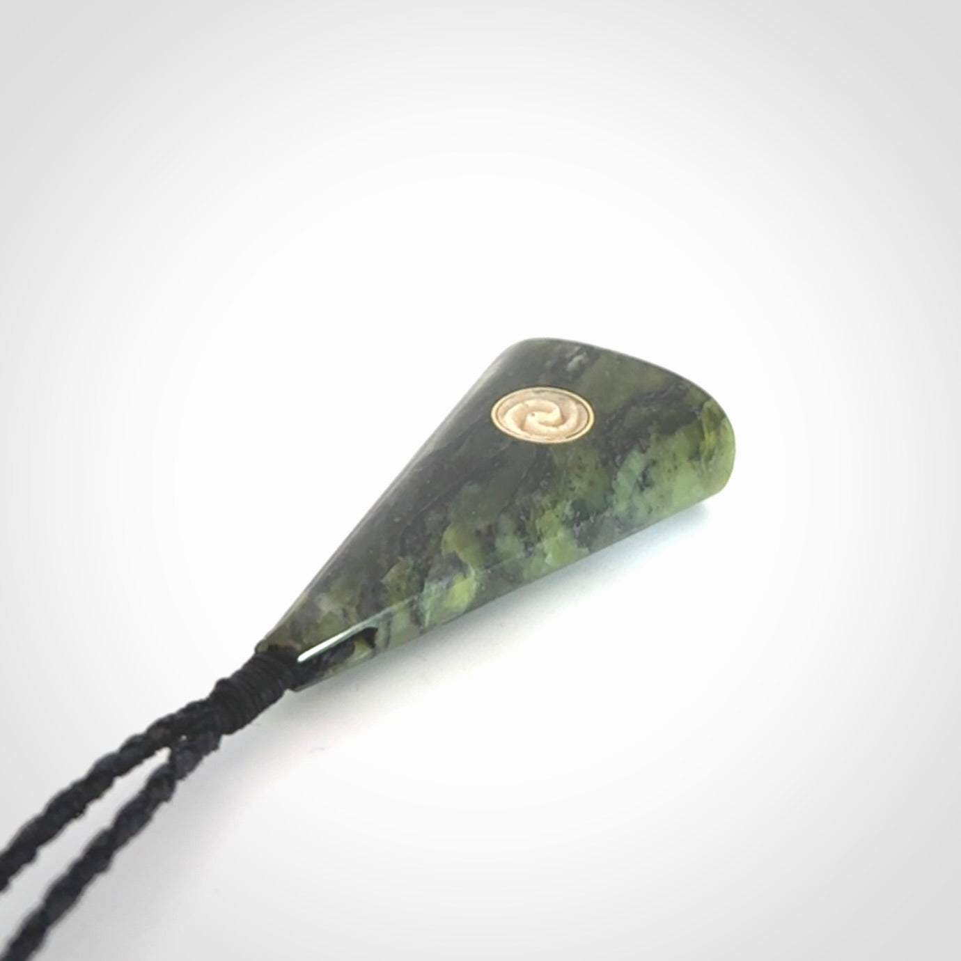 This is a wonderful New Zealand Jade drop pendant with whale bone koru and brass inlay.