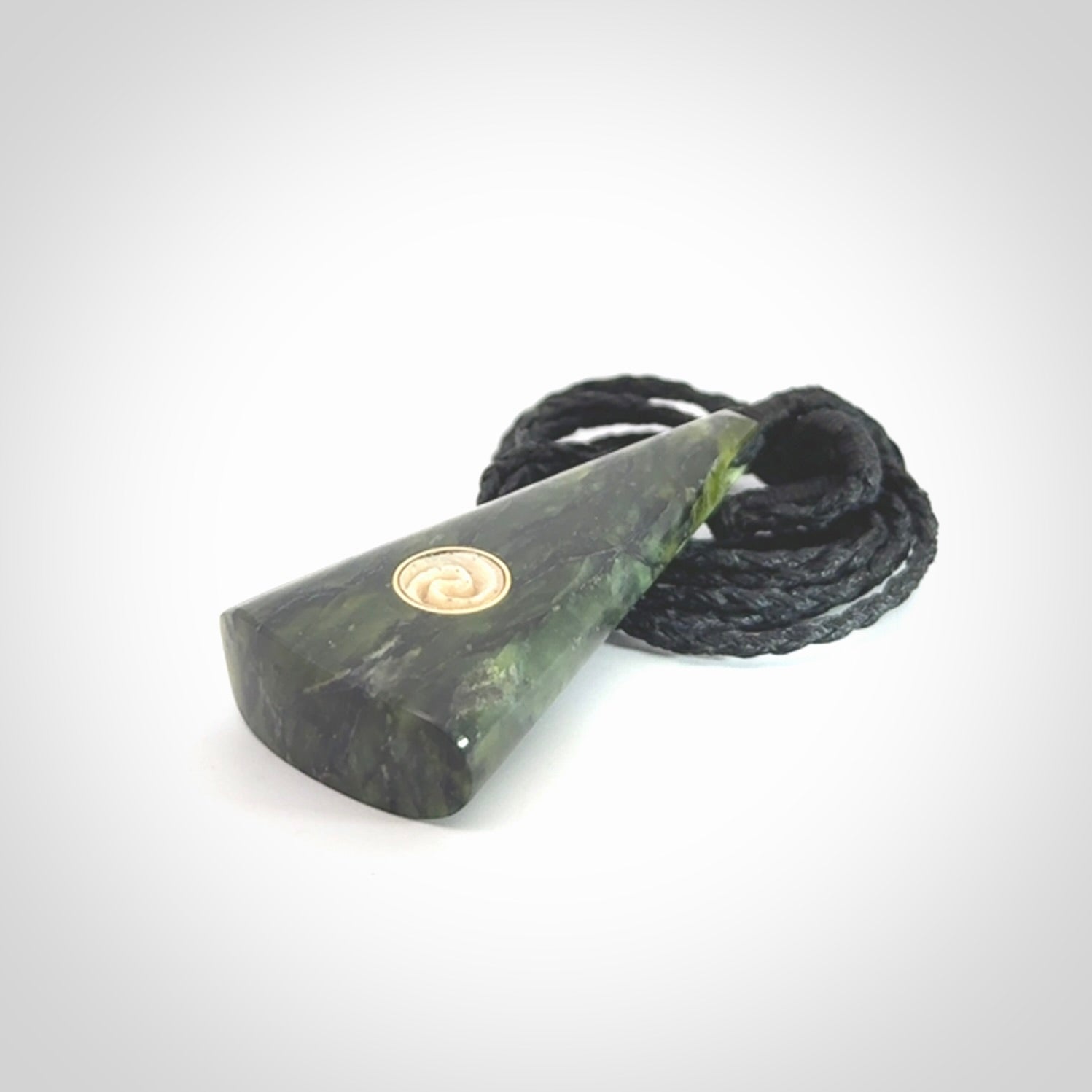 This is a wonderful New Zealand Jade drop pendant with whale bone koru and brass inlay.