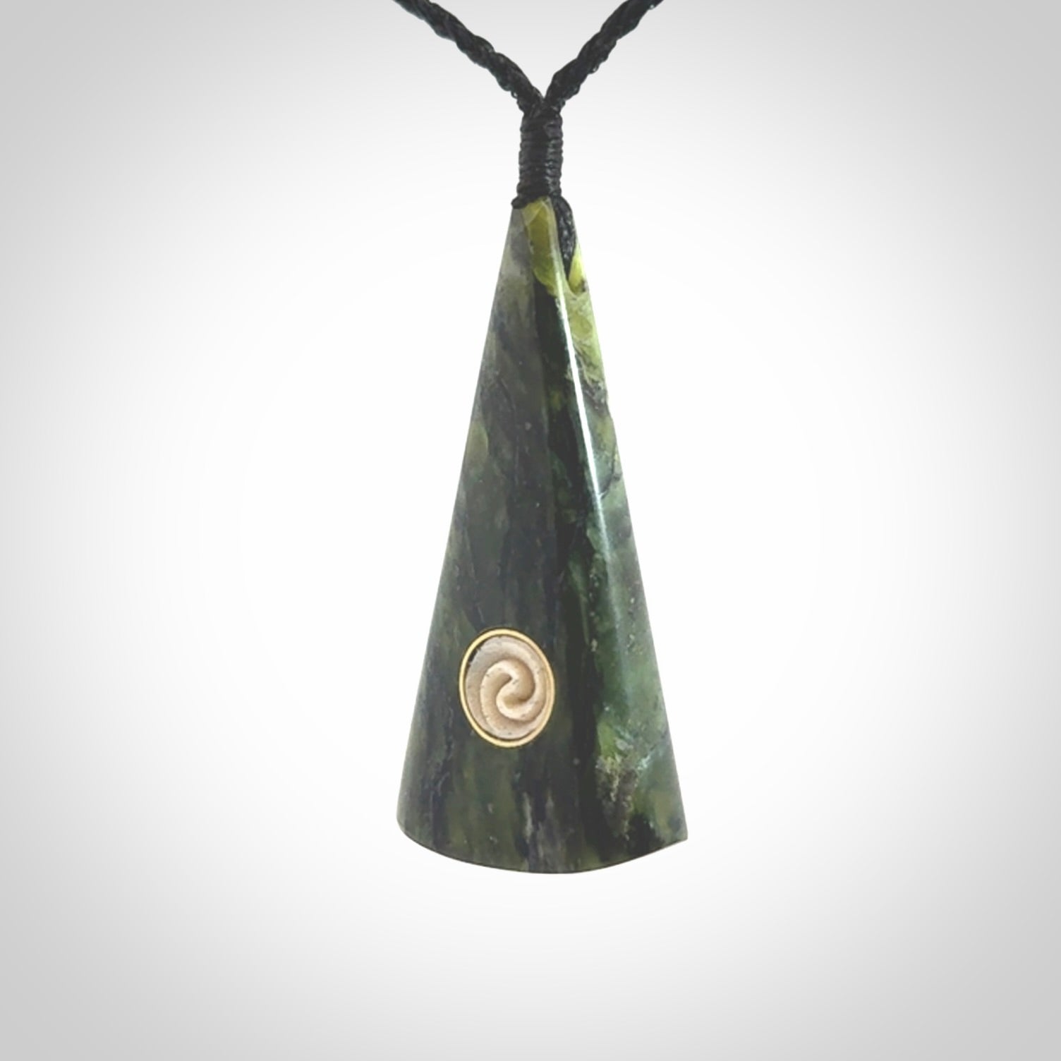 This is a wonderful New Zealand Jade drop pendant with whale bone koru and brass inlay.