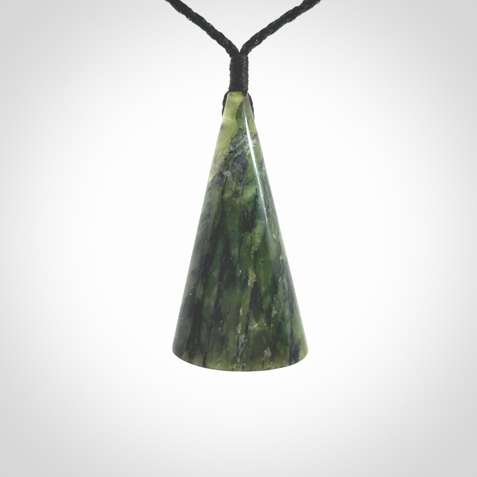 This is a wonderful New Zealand Jade drop pendant with whale bone koru and brass inlay.