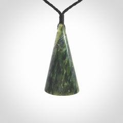 This is a wonderful New Zealand Jade drop pendant with whale bone koru and brass inlay.