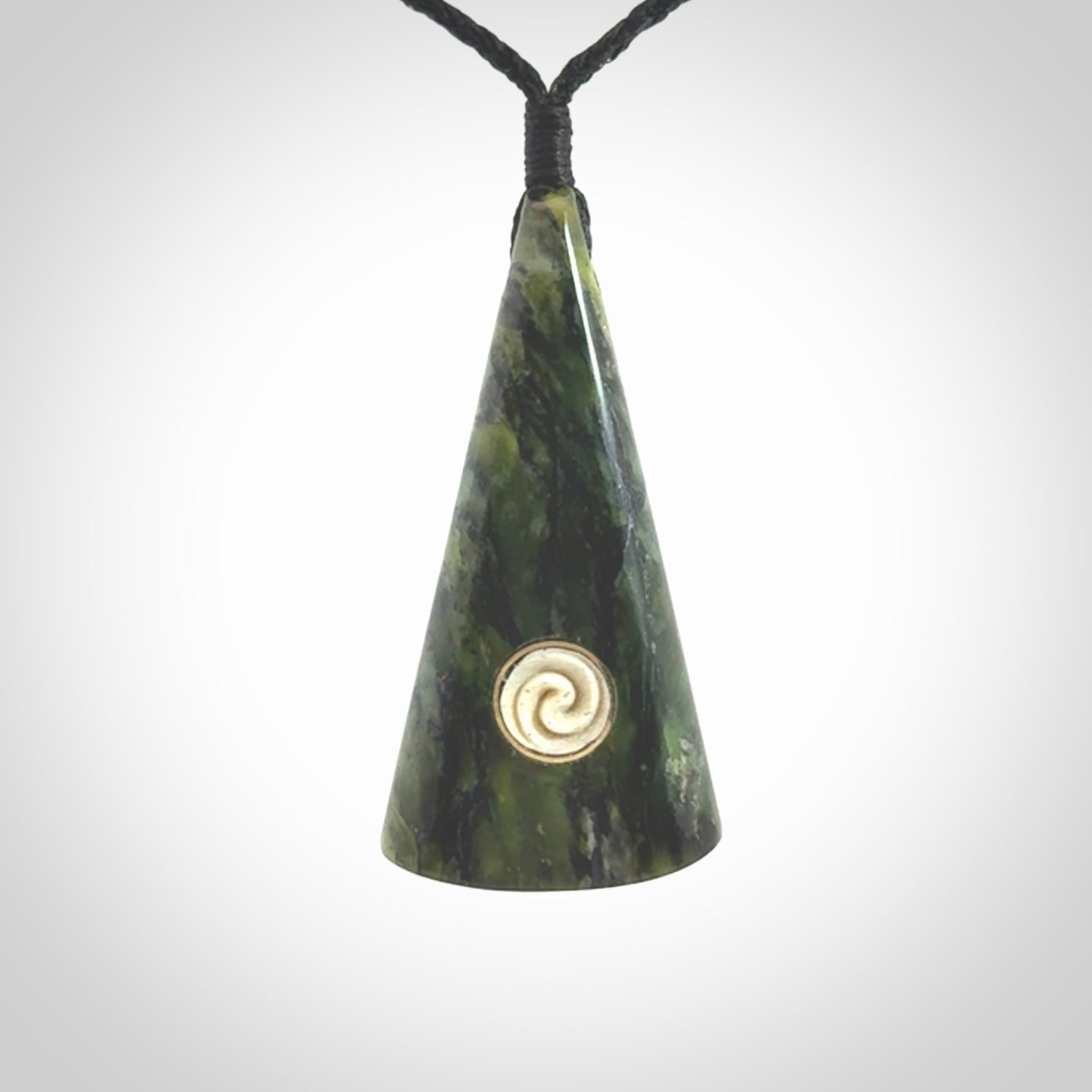 This is a wonderful New Zealand Jade drop pendant with whale bone koru and brass inlay.