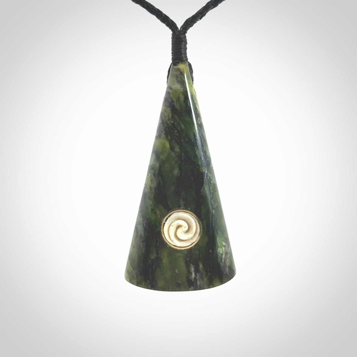 This is a wonderful New Zealand Jade drop pendant with whale bone koru and brass inlay.