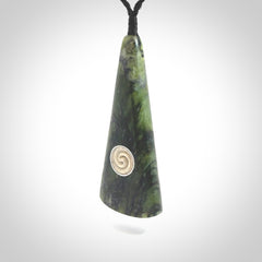 This is a wonderful New Zealand Jade drop pendant with whale bone koru and brass inlay.