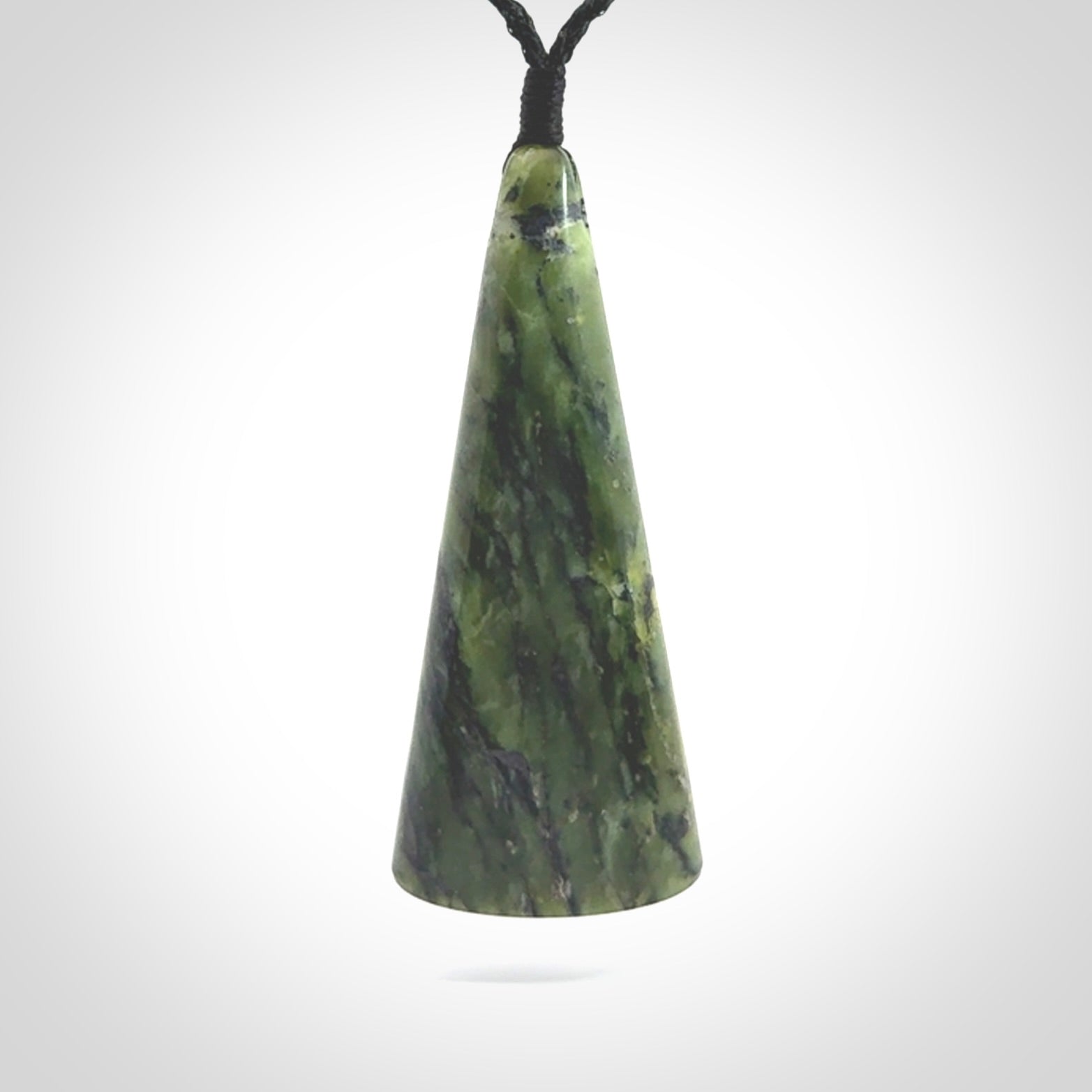 This is a wonderful New Zealand Jade drop pendant with whale bone koru and brass inlay.