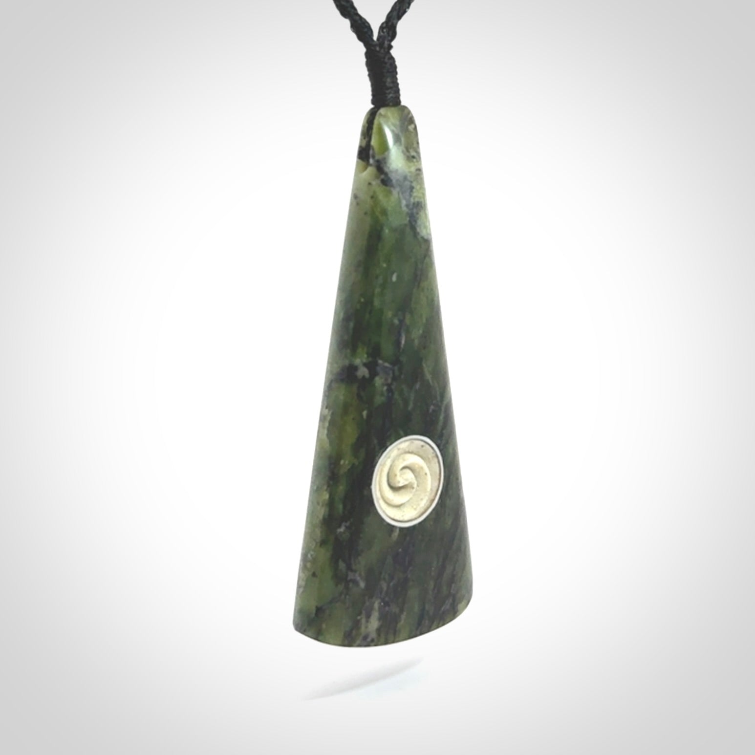 This is a wonderful New Zealand Jade drop pendant with whale bone koru and brass inlay.