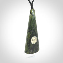 This is a wonderful New Zealand Jade drop pendant with whale bone koru and brass inlay.