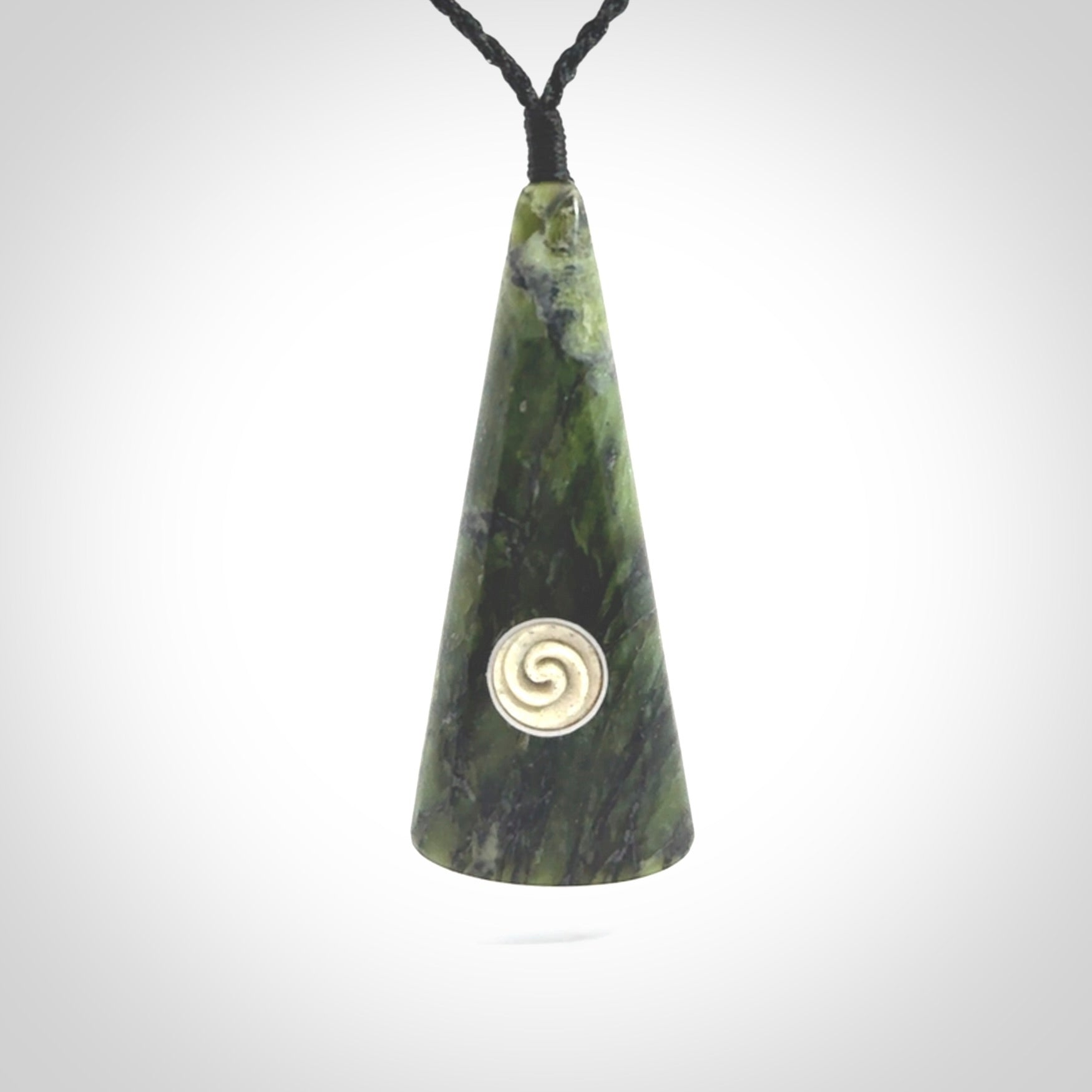 This is a wonderful New Zealand Jade drop pendant with whale bone koru and brass inlay.
