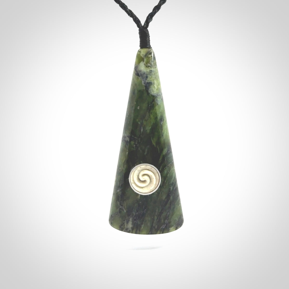 This is a wonderful New Zealand Jade drop pendant with whale bone koru and brass inlay.