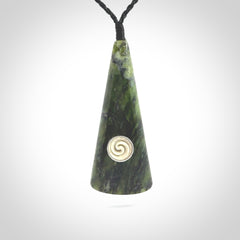 This is a wonderful New Zealand Jade drop pendant with whale bone koru and brass inlay.