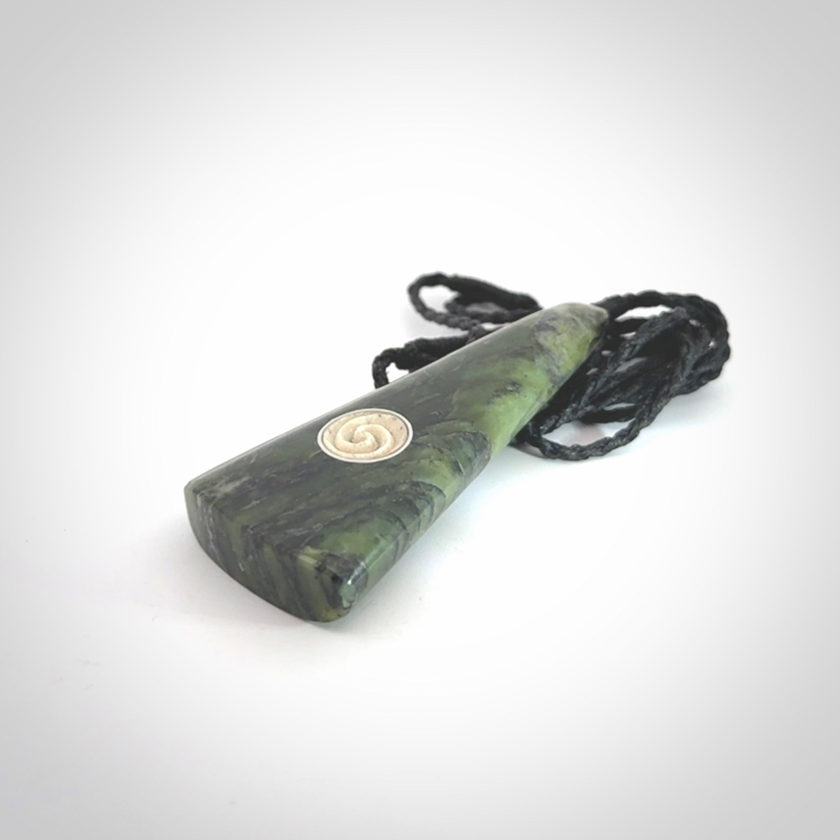 This is a wonderful New Zealand Jade drop pendant with whale bone koru and brass inlay.