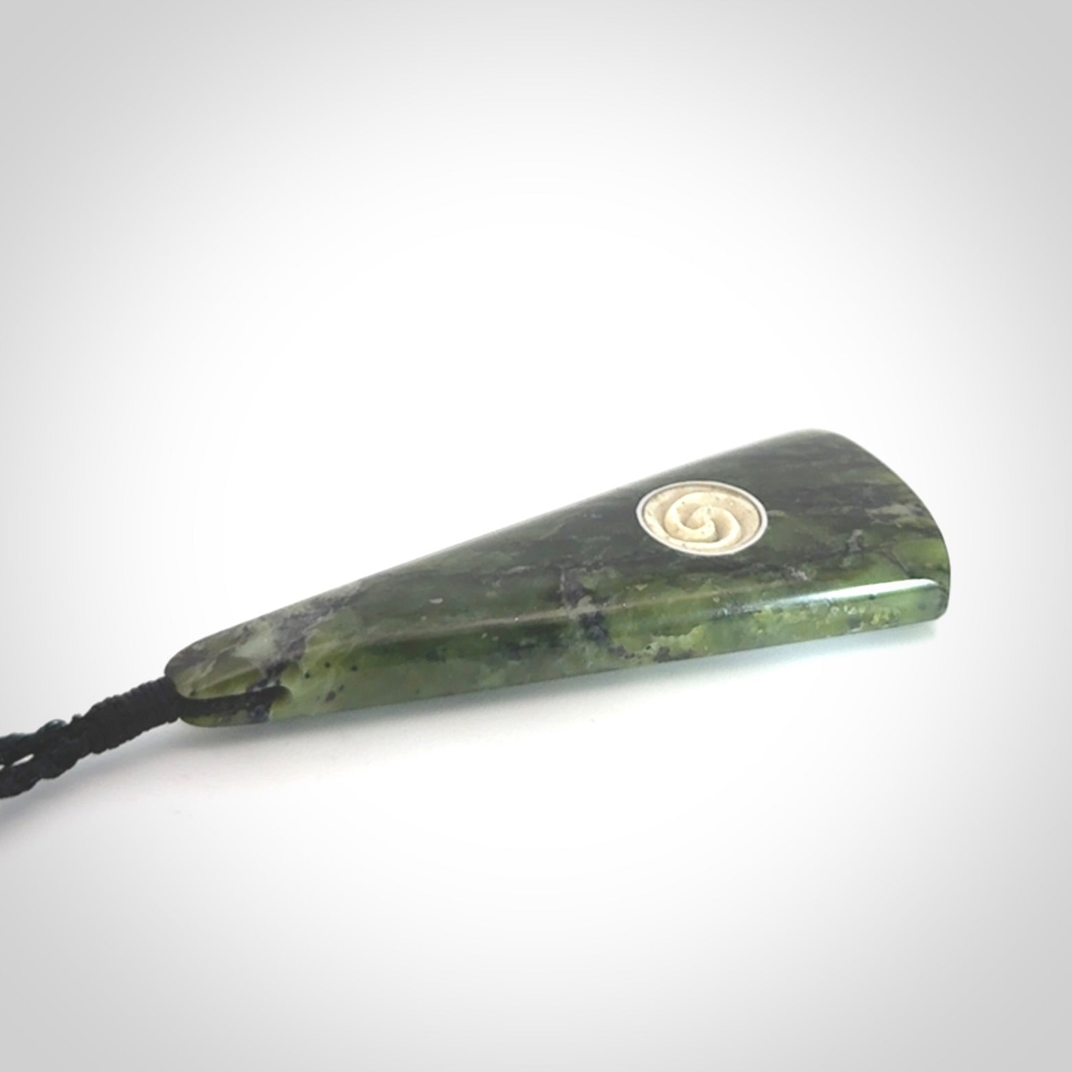 This is a wonderful New Zealand Jade drop pendant with whale bone koru and brass inlay.