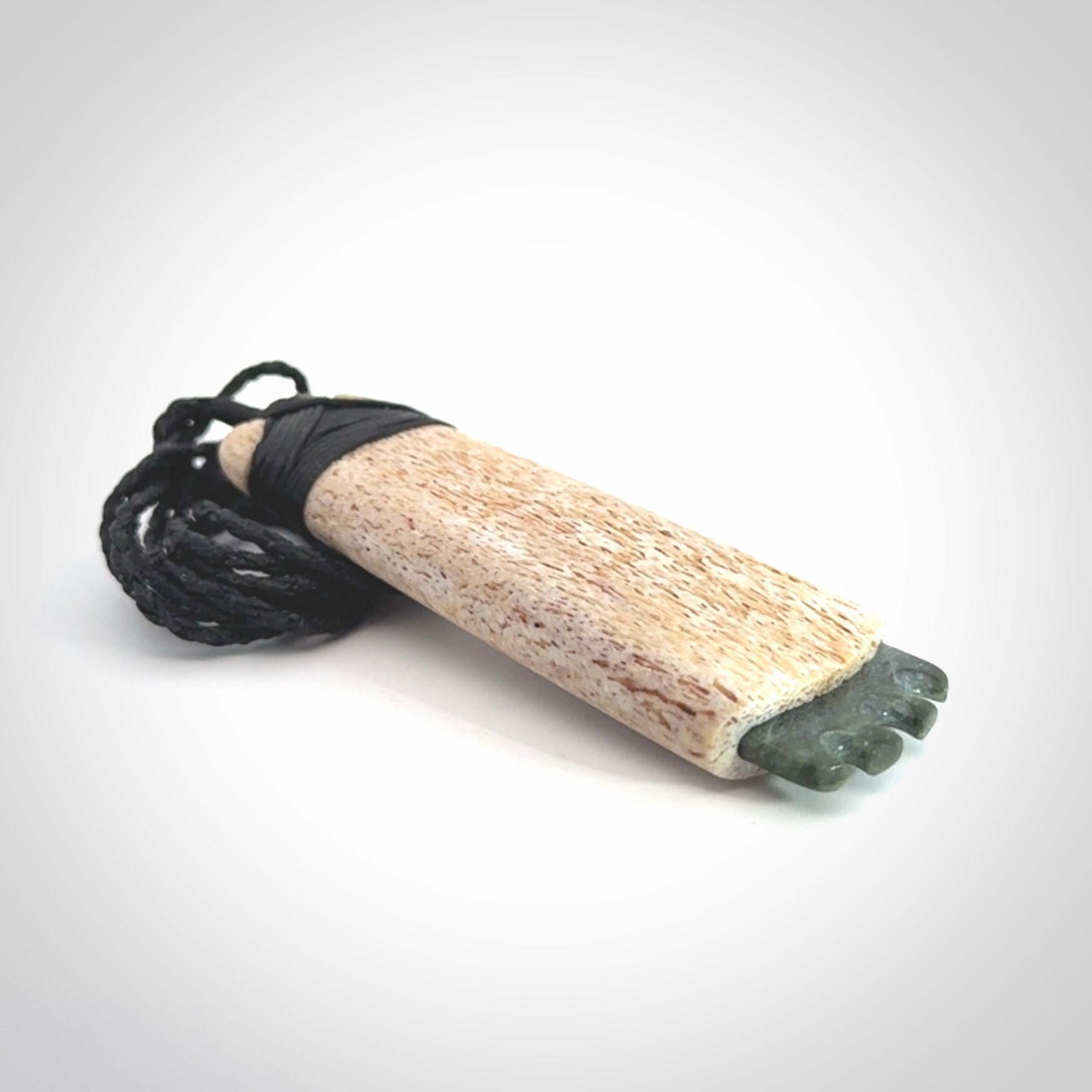 This is a wonderful large toki pendant. Hand made from whale bone and Jade. Delivered to you with an adjustable black cord.