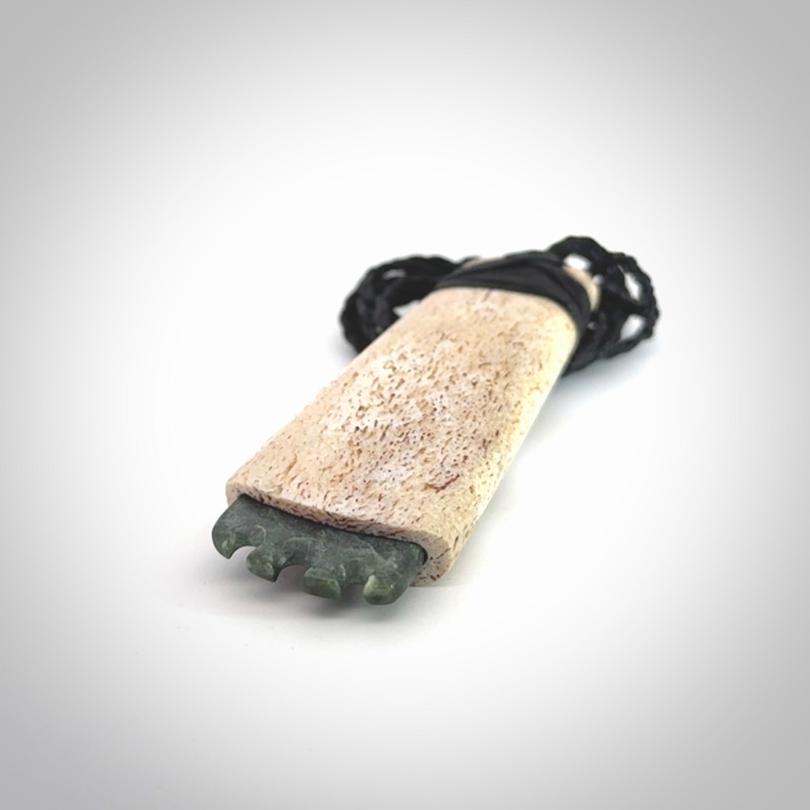 This is a wonderful large toki pendant. Hand made from whale bone and Jade. Delivered to you with an adjustable black cord.