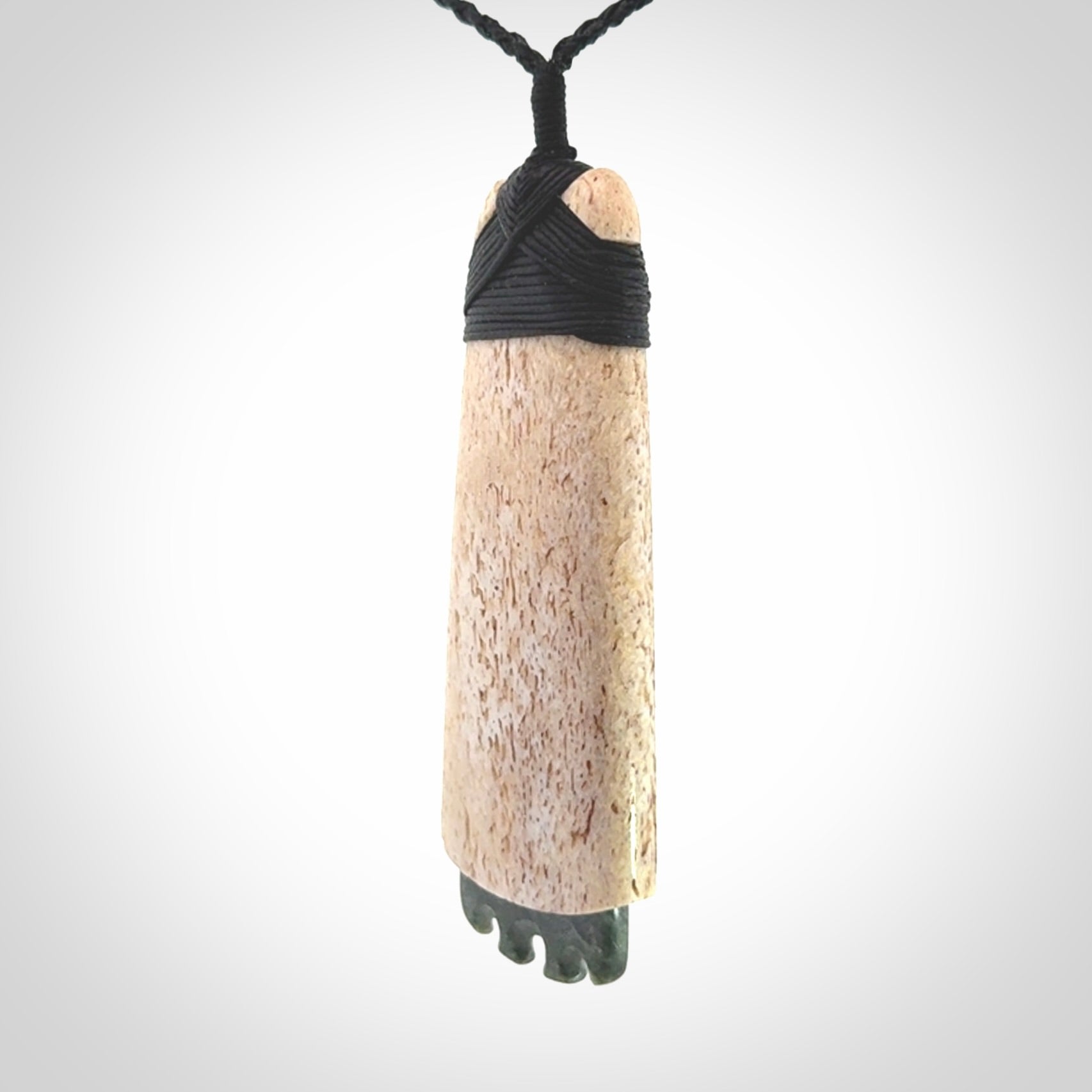 This is a wonderful large toki pendant. Hand made from whale bone and Jade. Delivered to you with an adjustable black cord.