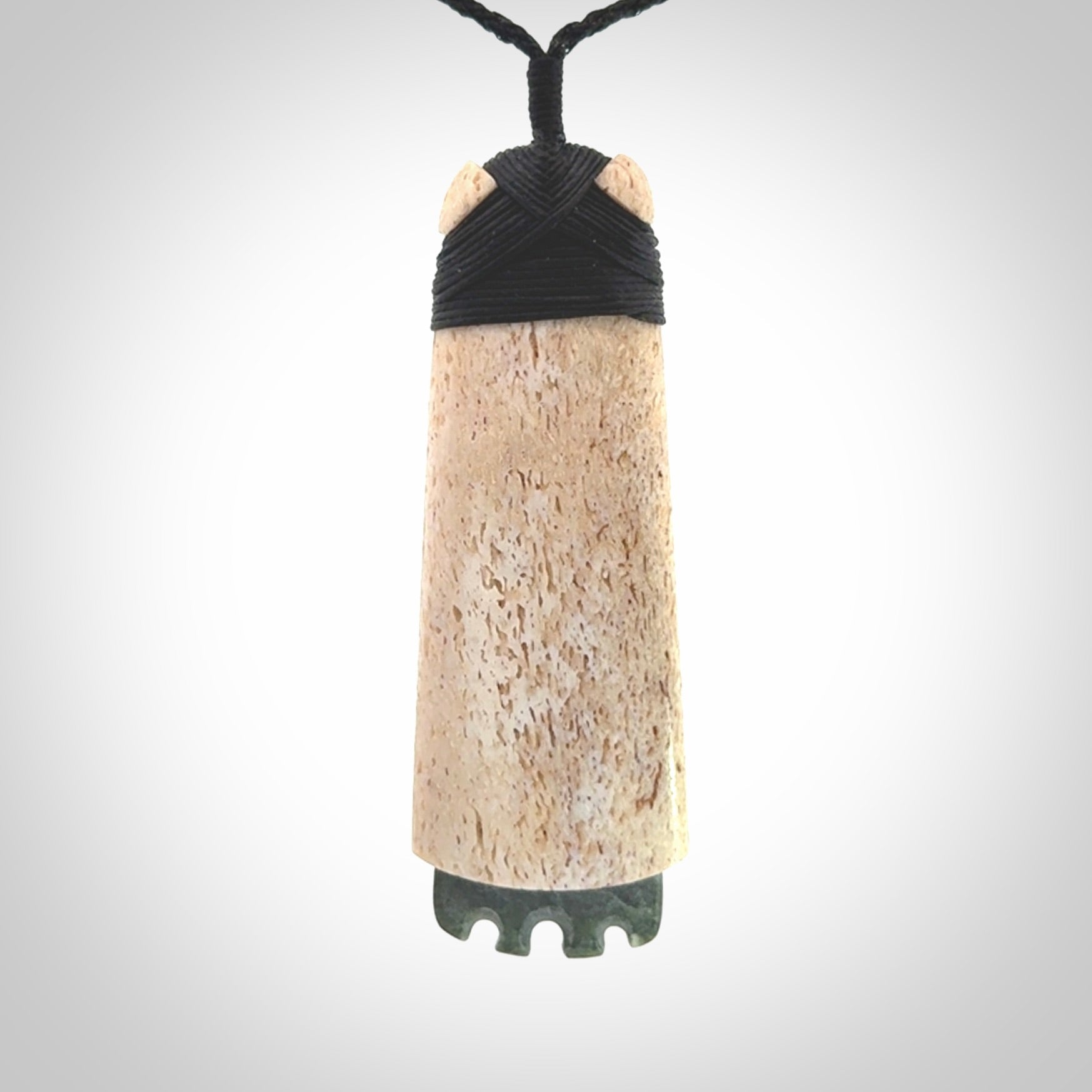 This is a wonderful large toki pendant. Hand made from whale bone and Jade. Delivered to you with an adjustable black cord.