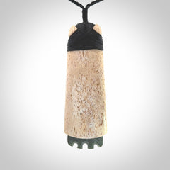 This is a wonderful large toki pendant. Hand made from whale bone and Jade. Delivered to you with an adjustable black cord.