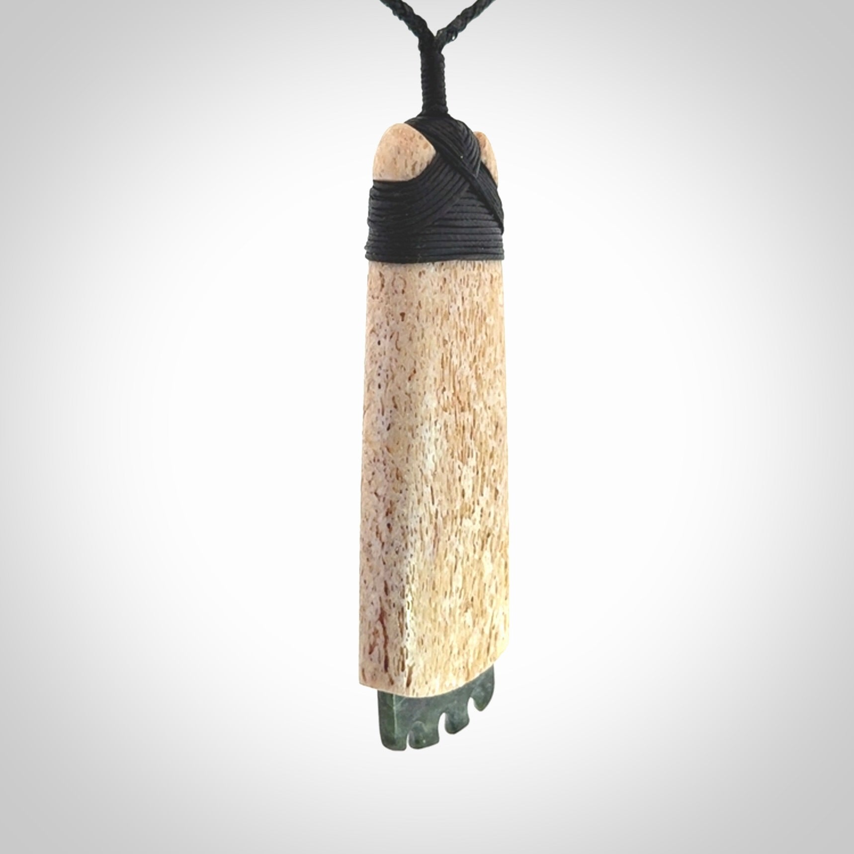 This is a wonderful large toki pendant. Hand made from whale bone and Jade. Delivered to you with an adjustable black cord.