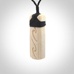 This is a wonderful, finely carved Toki pendant. It is hand carved by Andrew Doughty and we will ship it to you free anywhere in the world. Hand made from whale bone. Delivered to you with an adjustable black cord.