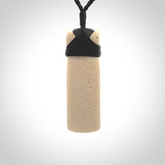 This is a wonderful, finely carved Toki pendant. It is hand carved by Andrew Doughty and we will ship it to you free anywhere in the world. Hand made from whale bone. Delivered to you with an adjustable black cord.