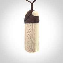 This is a wonderful whale bone toki pendant. Delivered to you with an adjustable brown cord.