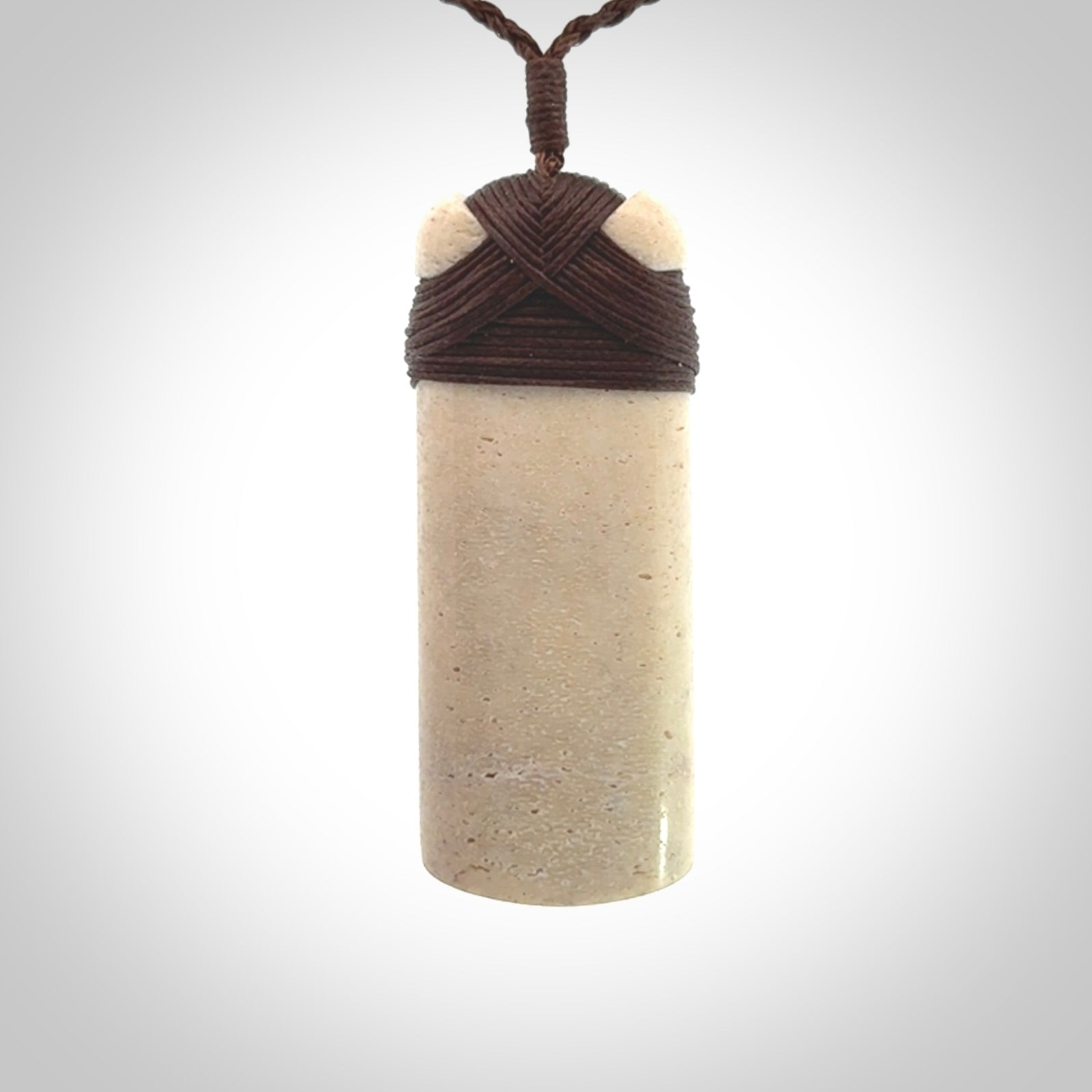 This is a wonderful whale bone toki pendant. Delivered to you with an adjustable brown cord.