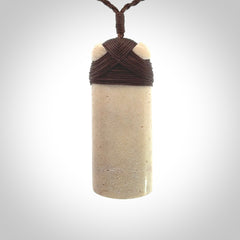 This is a wonderful whale bone toki pendant. Delivered to you with an adjustable brown cord.