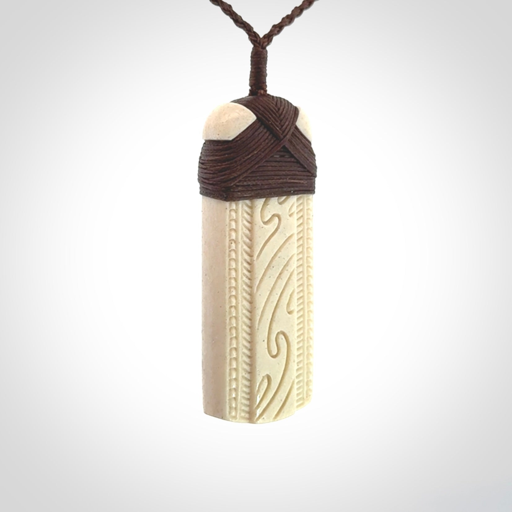 This is a wonderful whale bone toki pendant. Delivered to you with an adjustable brown cord.