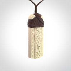 This is a wonderful whale bone toki pendant. Delivered to you with an adjustable brown cord.
