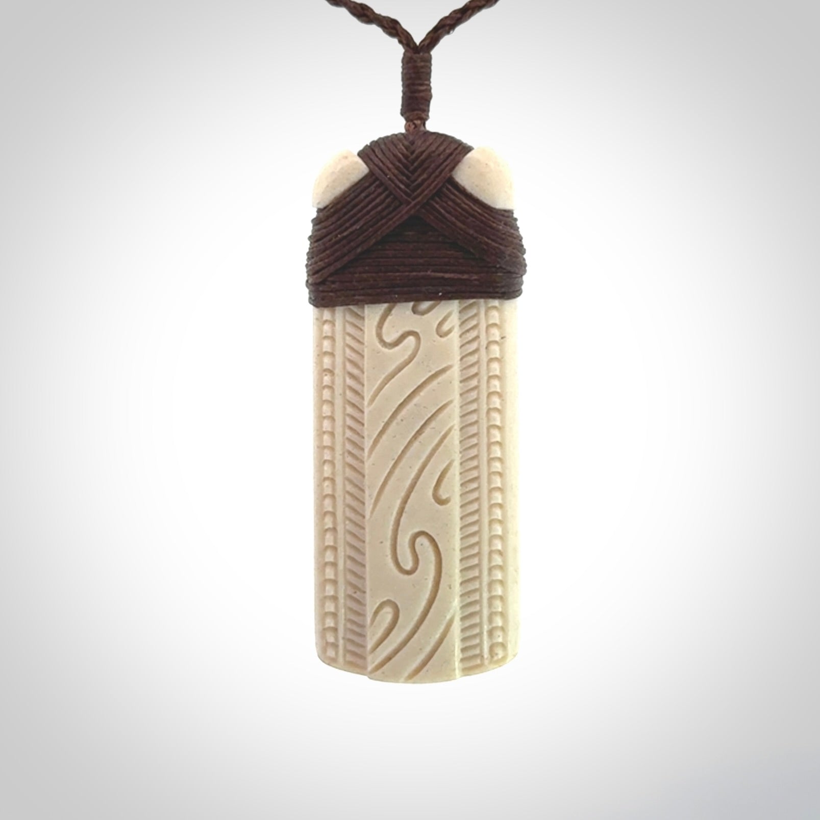 This is a wonderful whale bone toki pendant. Delivered to you with an adjustable brown cord.