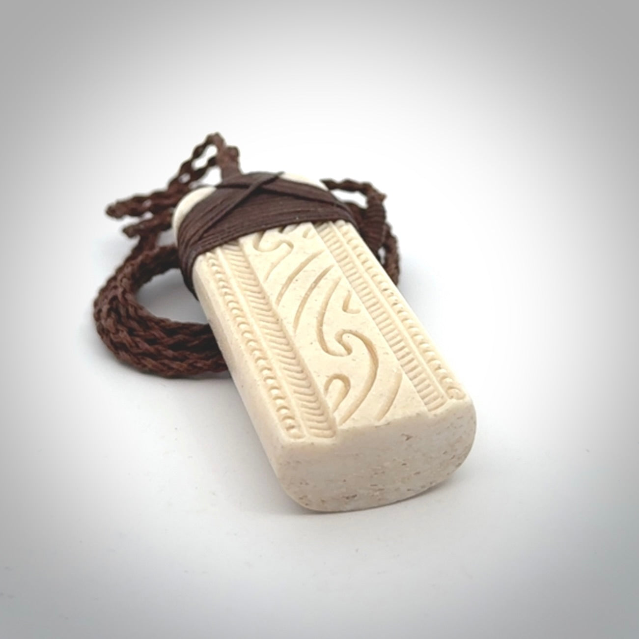 This is a wonderful whale bone toki pendant. Delivered to you with an adjustable brown cord.
