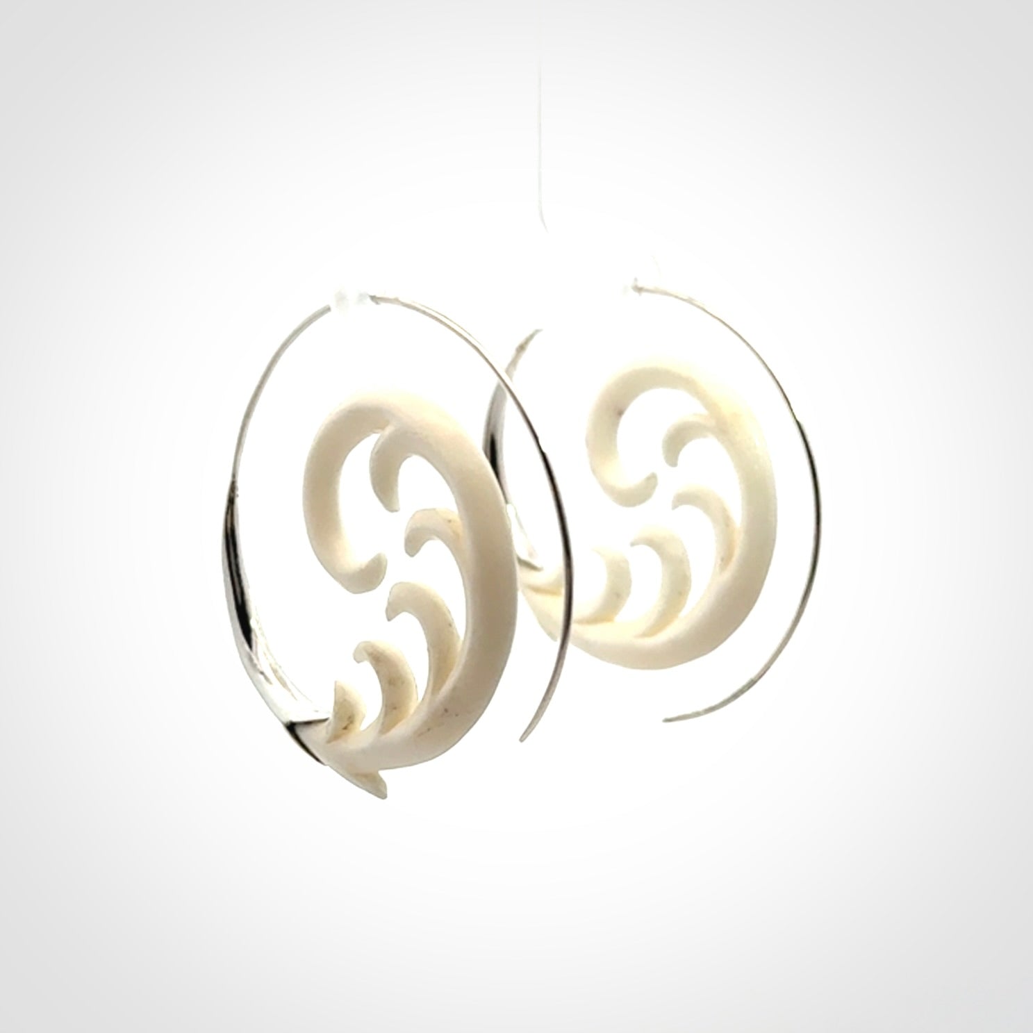 Hand carved earrings made from bone with sterling silver. NZ Pacific earrings for sale online.