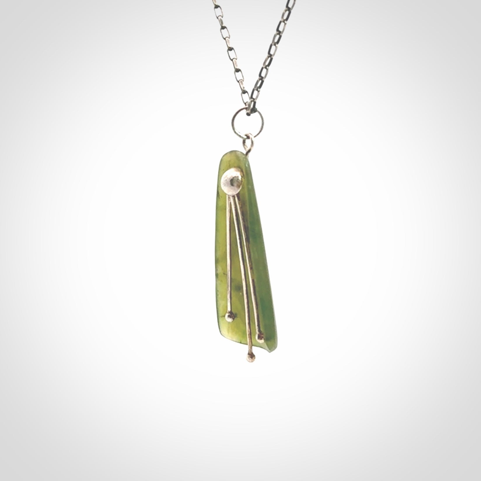 This kowhai flower drop pendant is beautifully hand made with gorgeous flair. It is fashionable and perfect for a women with style. Hand carved from a gorgeous piece of New Zealand jade with sterling silver - this is an elegant and beautiful piece of art to wear.