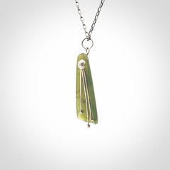 This kowhai flower drop pendant is beautifully hand made with gorgeous flair. It is fashionable and perfect for a women with style. Hand carved from a gorgeous piece of New Zealand jade with sterling silver - this is an elegant and beautiful piece of art to wear.