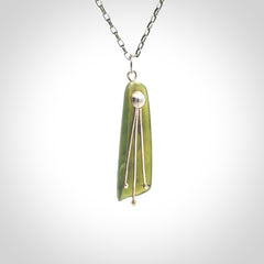 This kowhai flower drop pendant is beautifully hand made with gorgeous flair. It is fashionable and perfect for a women with style. Hand carved from a gorgeous piece of New Zealand jade with sterling silver - this is an elegant and beautiful piece of art to wear.