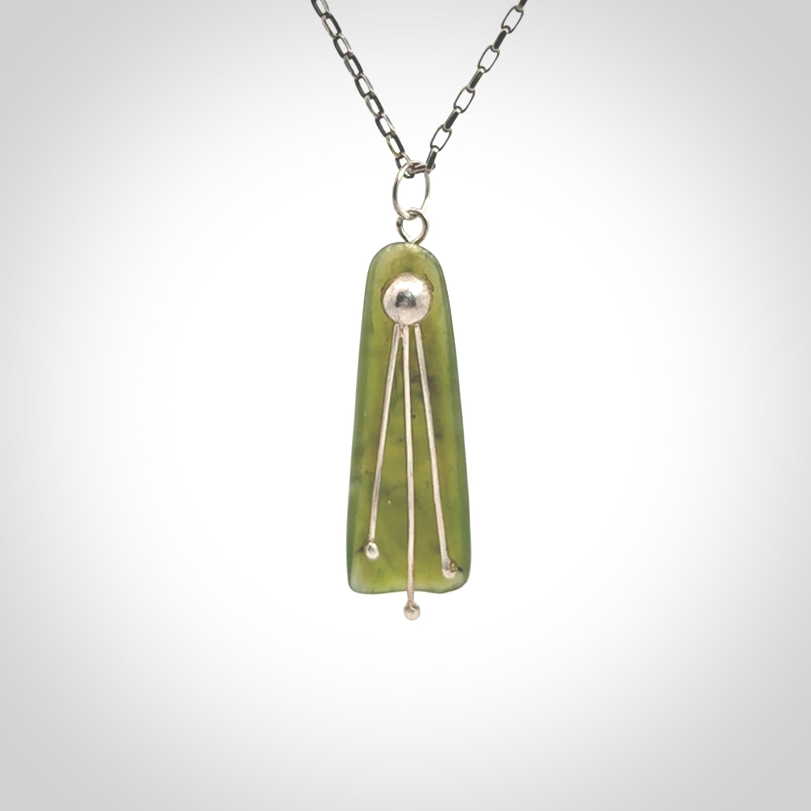 This kowhai flower drop pendant is beautifully hand made with gorgeous flair. It is fashionable and perfect for a women with style. Hand carved from a gorgeous piece of New Zealand jade with sterling silver - this is an elegant and beautiful piece of art to wear.