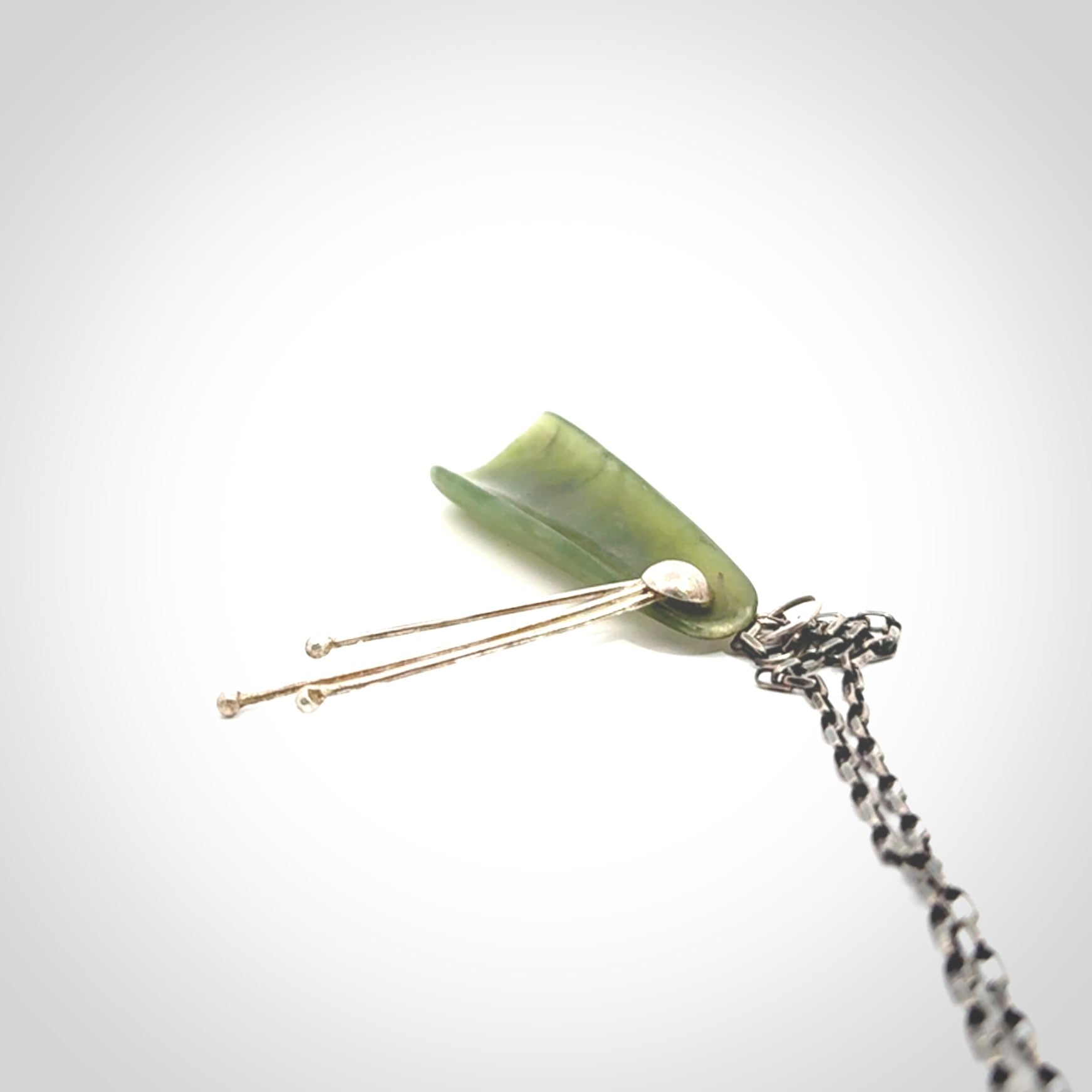This kowhai flower drop pendant is beautifully hand made with gorgeous flair. It is fashionable and perfect for a women with style. Hand carved from a gorgeous piece of New Zealand jade with sterling silver - this is an elegant and beautiful piece of art to wear.