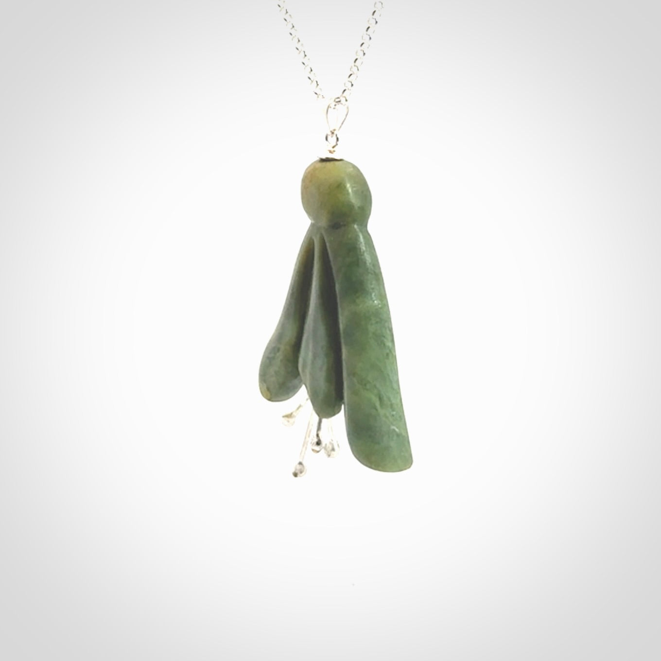 This picture shows a beautiful flower jade flower pendant with sterling silver flowers. This is a spectacular work of art and is a one off piece. Hand carved from New Zealand Flower Jade with sterling silver flowers, replicating a beautiful flower.