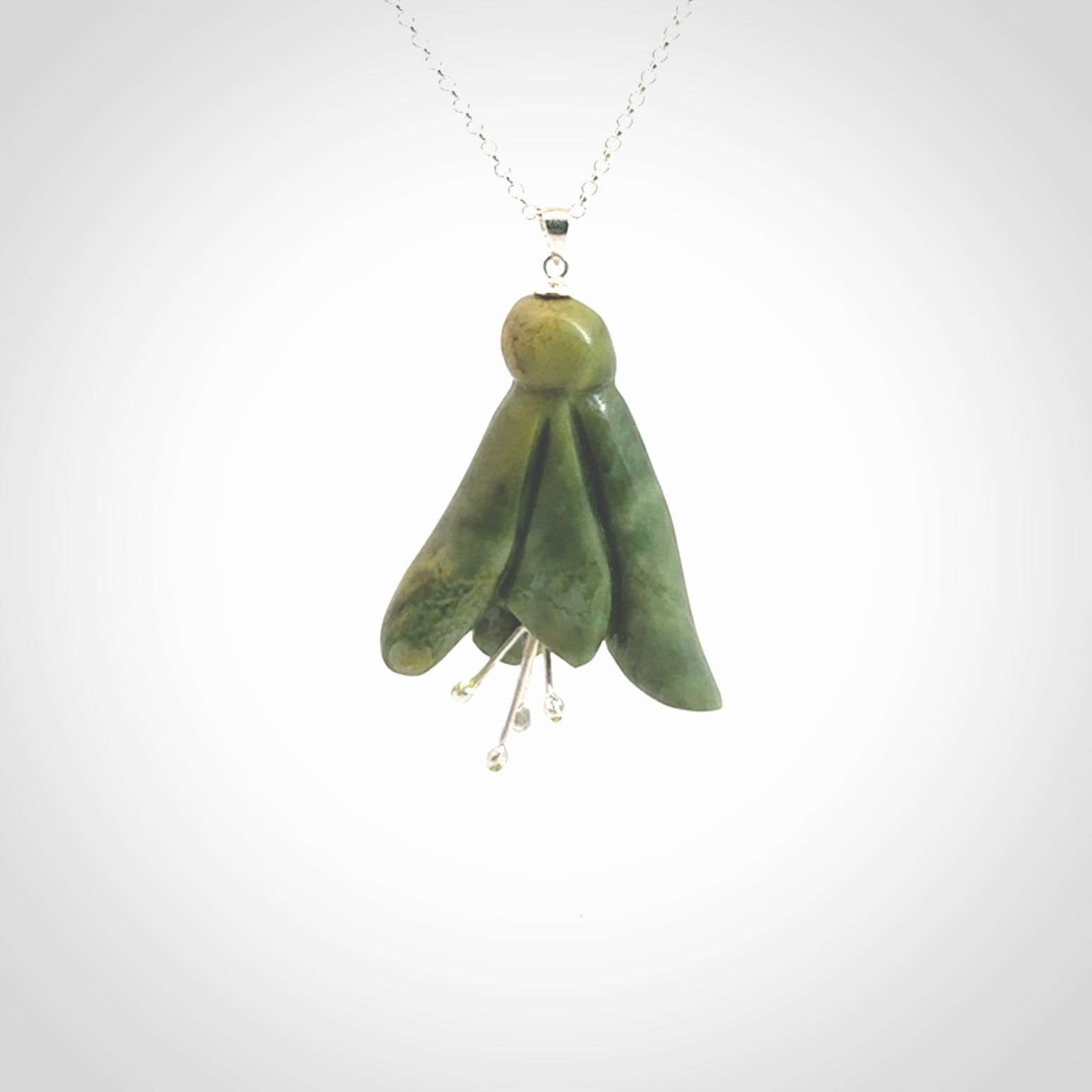 This picture shows a beautiful flower jade flower pendant with sterling silver flowers. This is a spectacular work of art and is a one off piece. Hand carved from New Zealand Flower Jade with sterling silver flowers, replicating a beautiful flower.