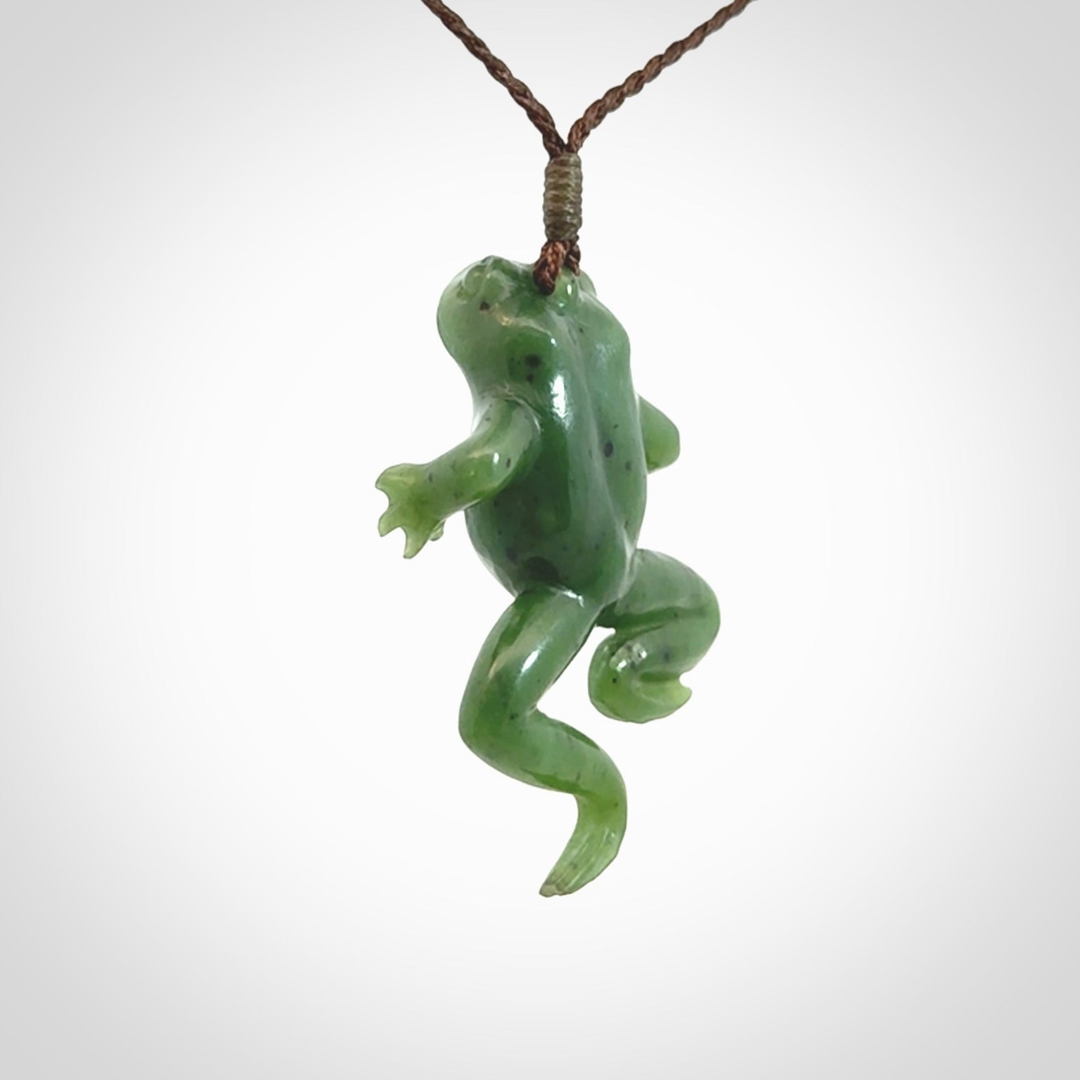 A hand carved jade frog pendant - he's carved to make you smile!
