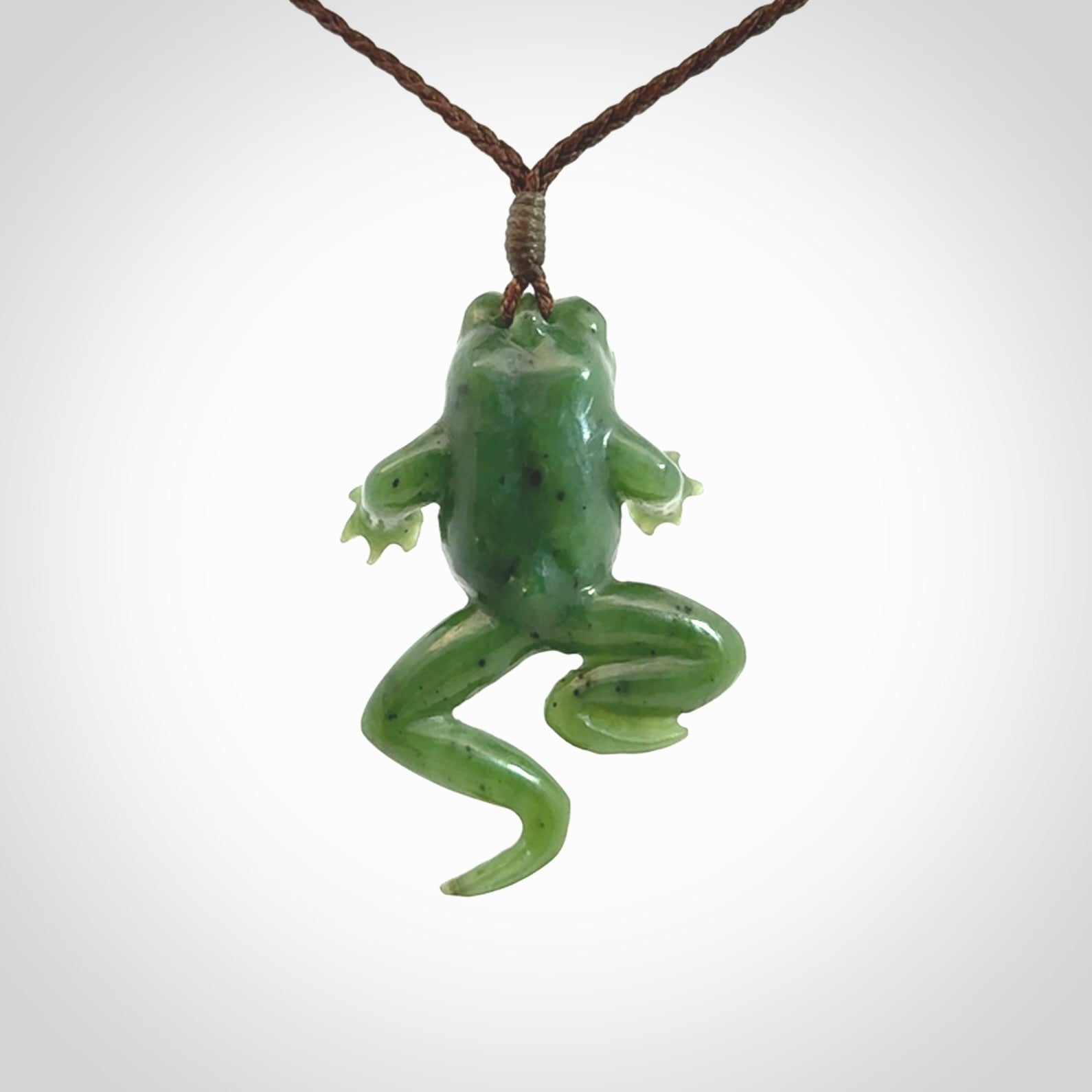 A hand carved jade frog pendant - he's carved to make you smile!
