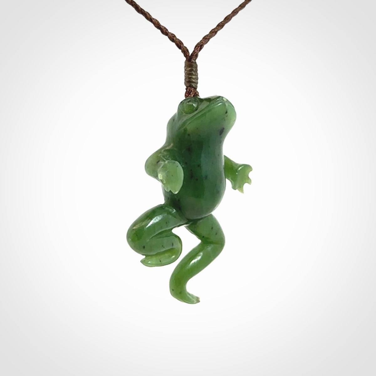 A hand carved jade frog pendant - he's carved to make you smile!