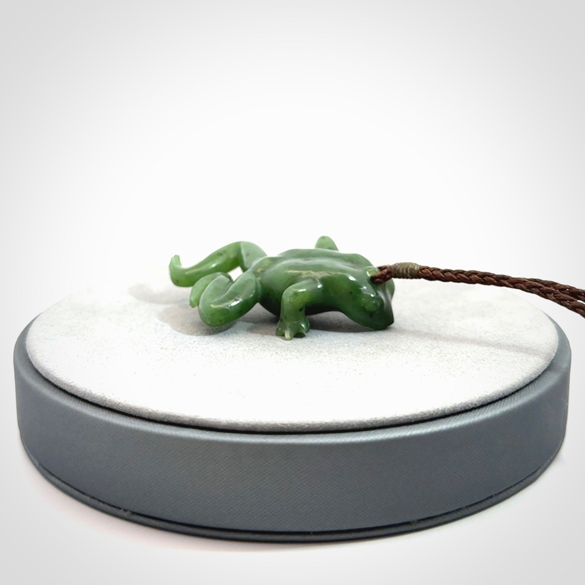 A hand carved jade frog pendant - he's carved to make you smile!