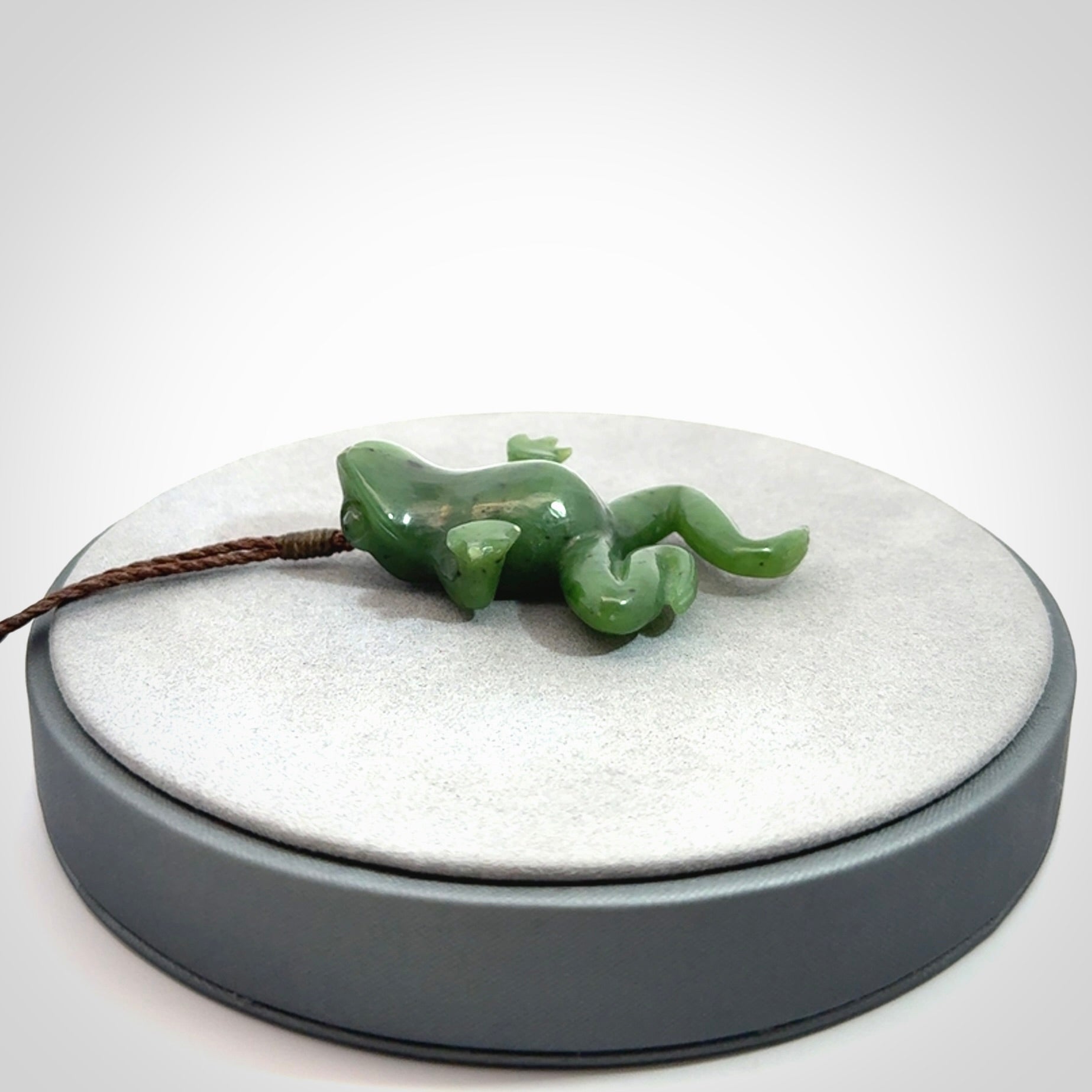 A hand carved jade frog pendant - he's carved to make you smile!