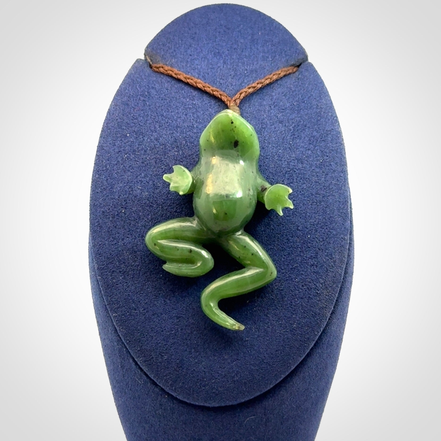 A hand carved jade frog pendant - he's carved to make you smile!