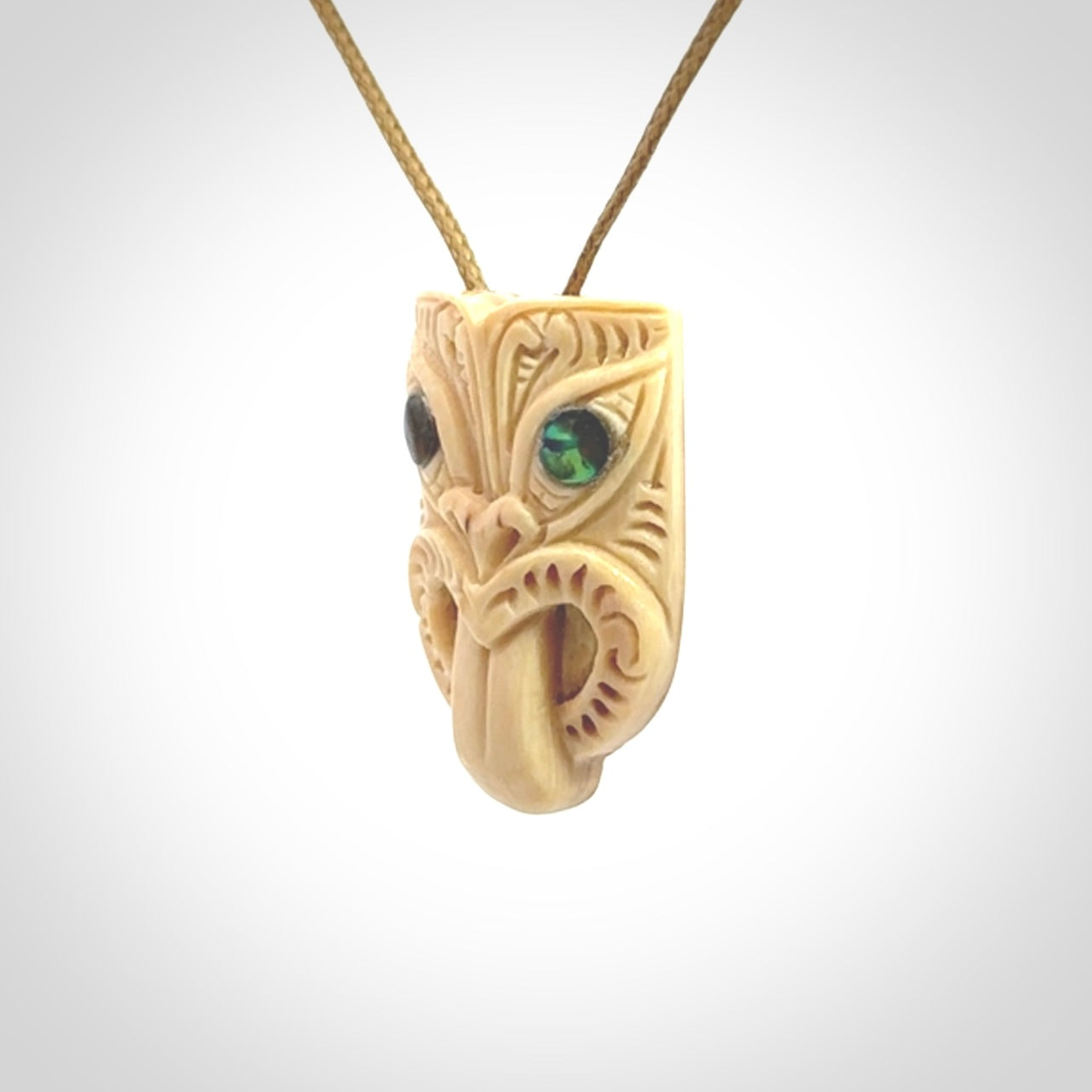 Hand carved Wheku pendant. Carved from woolly mammoth Tusk by NZ Pacific. Hand crafted Mammoth tusk jewellery for sale online. Provided with an adjustable cord and packaged in woven kete pouch.