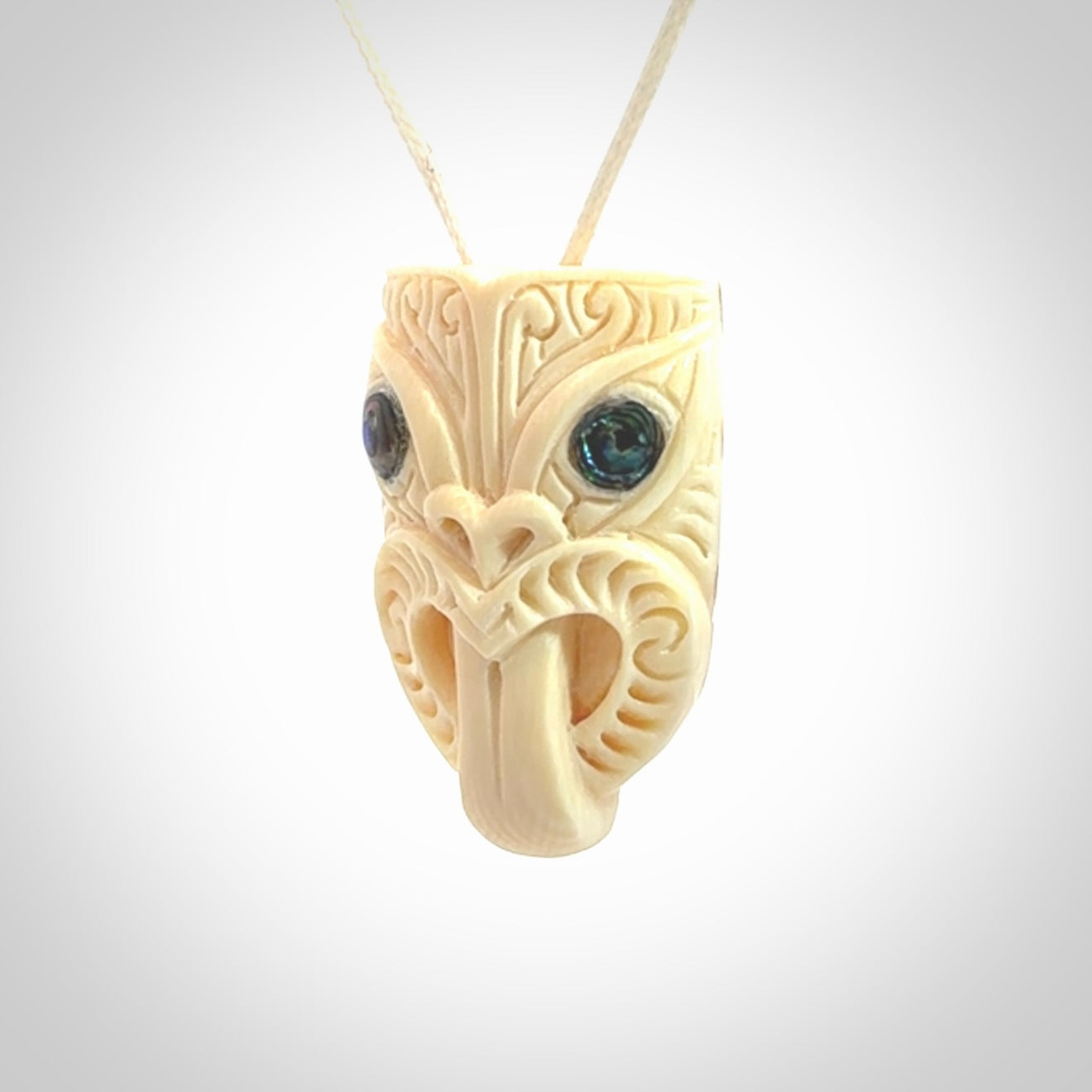 Hand carved Wheku pendant. Carved from woolly mammoth Tusk by NZ Pacific. Hand crafted Mammoth tusk jewellery for sale online. Provided with an adjustable cord and packaged in woven kete pouch.