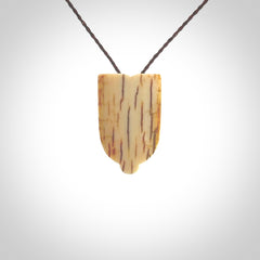 Hand carved Wheku pendant. Carved from woolly mammoth Tusk by NZ Pacific. Hand crafted Mammoth tusk jewellery for sale online. Provided with an adjustable cord and packaged in woven kete pouch.